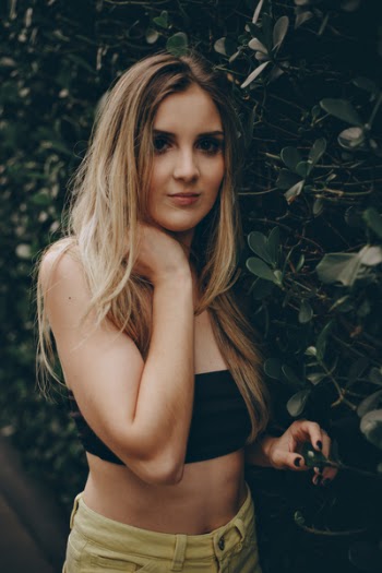 Photo of Woman Standing Near Bushes