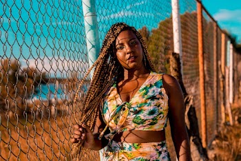 Photo Of Woman Standing Near Chain Link Fence