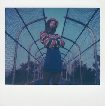 Photo Of Woman Standing Near Chain Link Fence