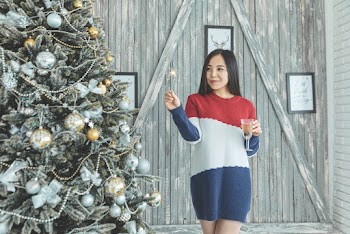 Photo of Woman Standing Near Christmas Tree