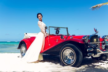 Photo of Woman Standing Near Classic Car