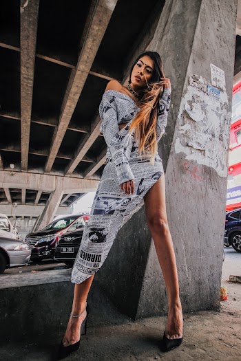 Photo Of Woman Standing Near Column