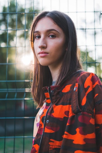 Photo Of Woman Standing Near Fence