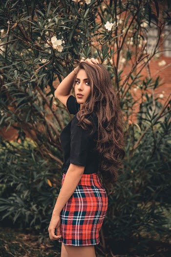 Photo of Woman Standing Near Flowering Plants