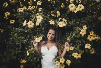 Photo of Woman Standing Near Flowers