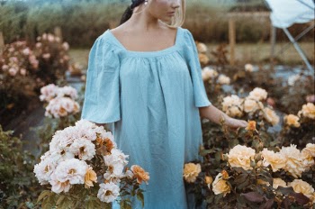 Photo Of Woman Standing Near Flowers