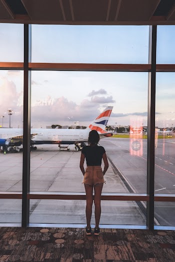 Photo of Woman Standing Near Glass Wall