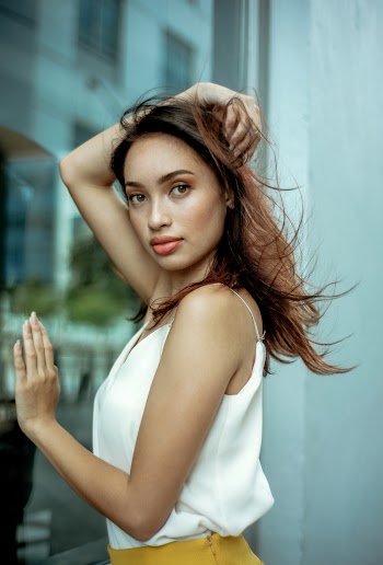 Photo of Woman Standing Near Glass Wall