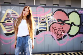 Photo Of Woman Standing Near Graffiti