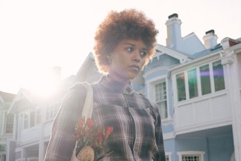 Photo Of Woman Standing Near Houses