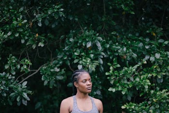 Photo Of Woman Standing Near Leaves