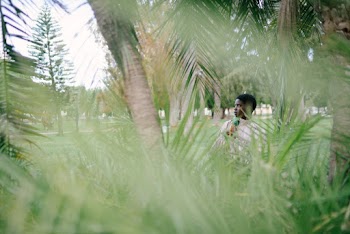 Photo Of Woman Standing Near Palm Tree