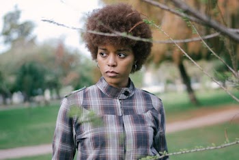Photo Of Woman Standing Near Plant