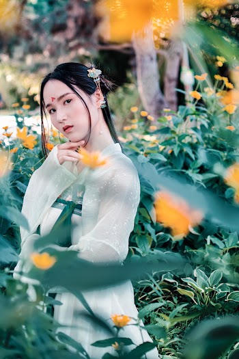 Photo Of Woman Standing Near Plants
