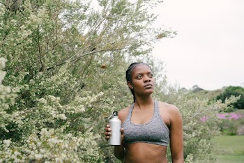 Photo Of Woman Standing Near Plants