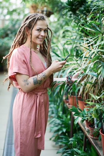 Photo of Woman Standing Near Plants