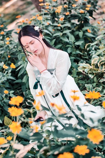 Photo Of Woman Standing Near Plants