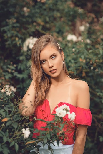 Photo Of Woman Standing Near Plants
