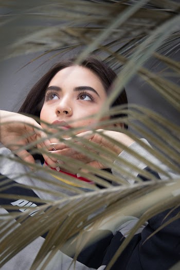 Photo Of Woman Standing Near Plants