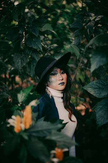 Photo Of Woman Standing Near Plants