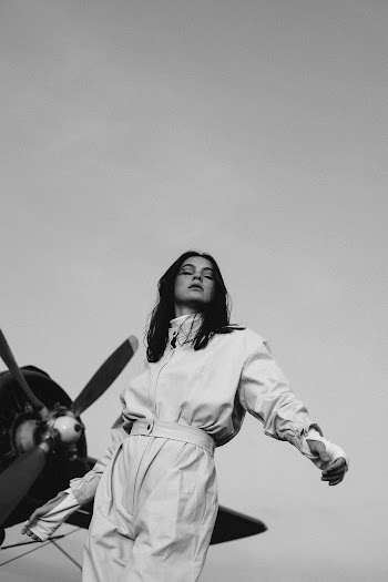 Photo Of Woman Standing Near Propeller