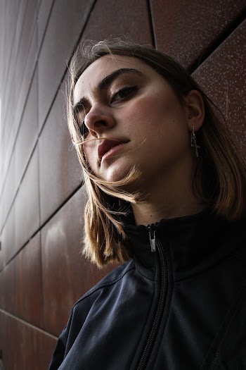 Photo of Woman Standing Near the Wall