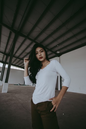 Photo Of Woman Standing Near White Wall 