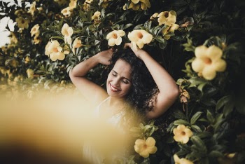 Photo of Woman Standing Near Yellow Flowers