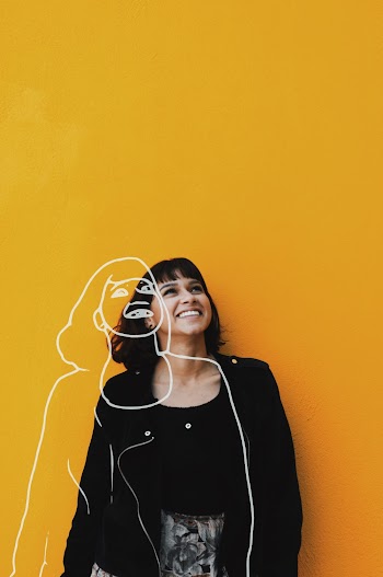 Photo Of Woman Standing Near Yellow Wall