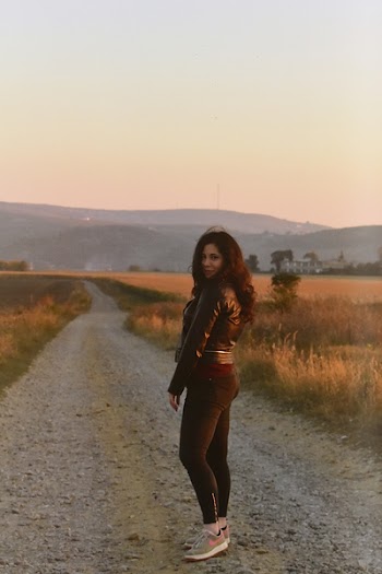 Photo of Woman Standing on Dirt Road