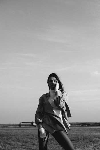 Photo Of Woman Standing On Grass Field