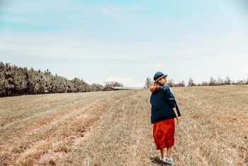 Photo of Woman Standing on Grass Field