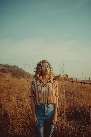 Photo of Woman Standing on Grass Field