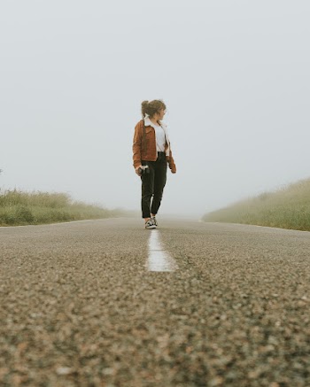 Photo Of Woman Standing On Highway