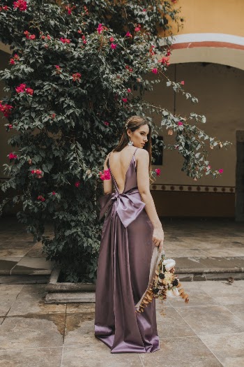 Photo of Woman Standing on Pavement Near Plant