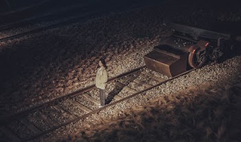 Photo Of Woman Standing On Railroad