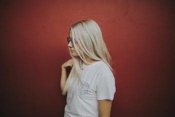 Photo of Woman Standing on Red Background