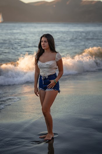 Photo Of Woman Standing On Seashore