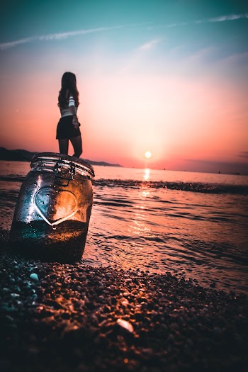 Photo of Woman Standing on Seashore