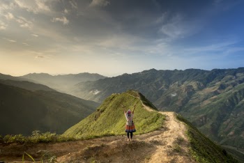 Photo of Woman Standing On Top Of Mountain