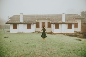 Photo Of Woman Standing Outside House