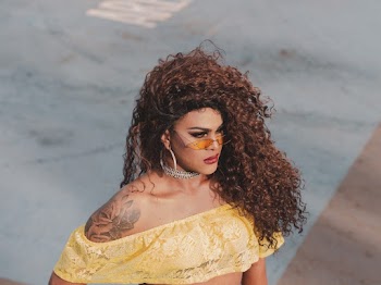 Photo of Woman Standing Wearing Yellow Crop Top and Sunglasses