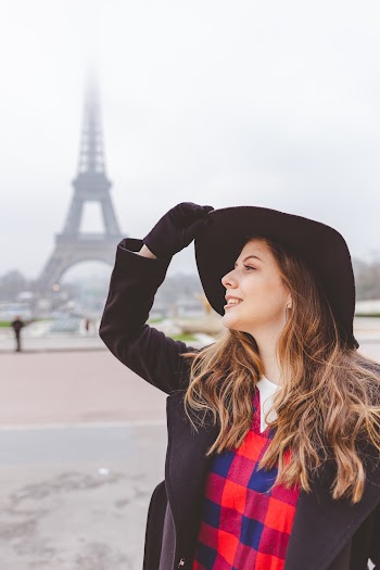 Photo of Woman Standing with Eiffel Tower in the Background