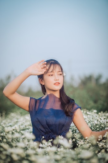 Photo Of Woman Surrounded By White Flowers