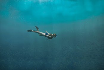 Photo of Woman Swimming Underwater