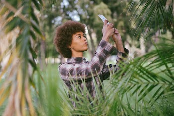 Photo Of Woman Taking Picture Of Plants