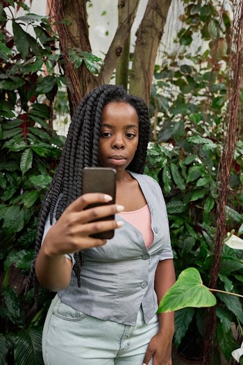 Photo of Woman Taking Selfie Near Plants