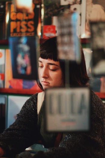 photo of woman through glass
