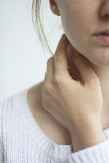 Photo of Woman Touching Her Neck