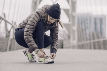 Photo of Woman Tying Her Shoe